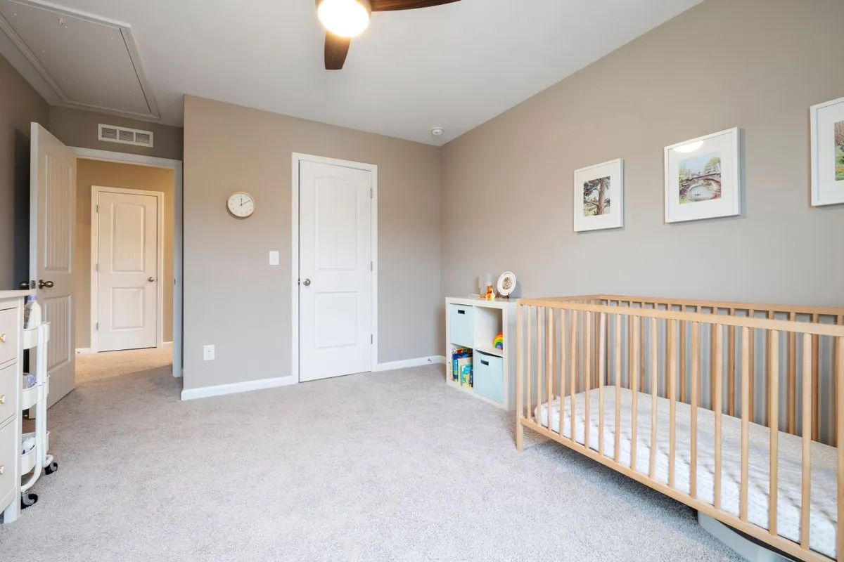 Parent and baby at home, device quietly working nearby